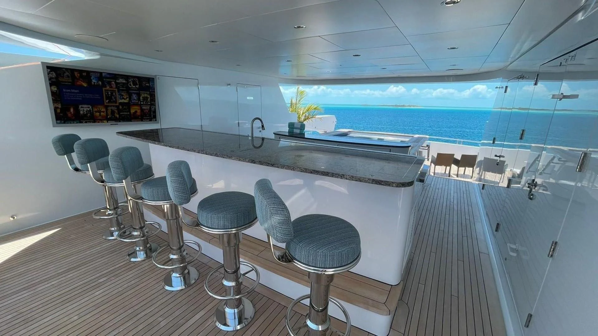 a room with a table chairs and a pool aboard LADY BETH Yacht for Sale