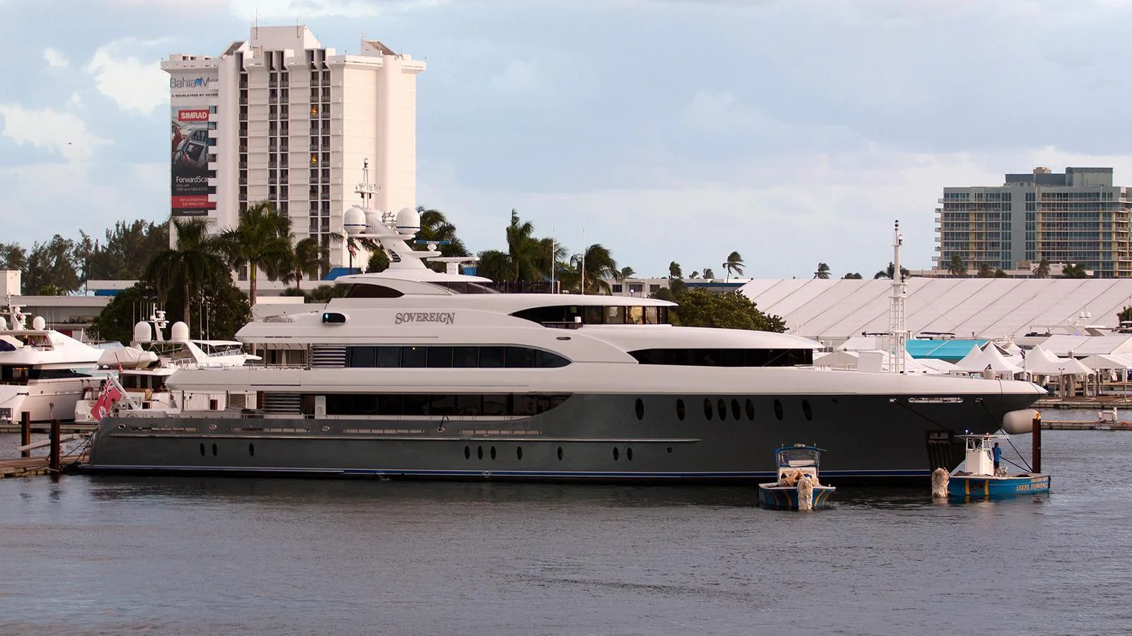 a large white boat in a harbor aboard LADY BETH Yacht for Sale