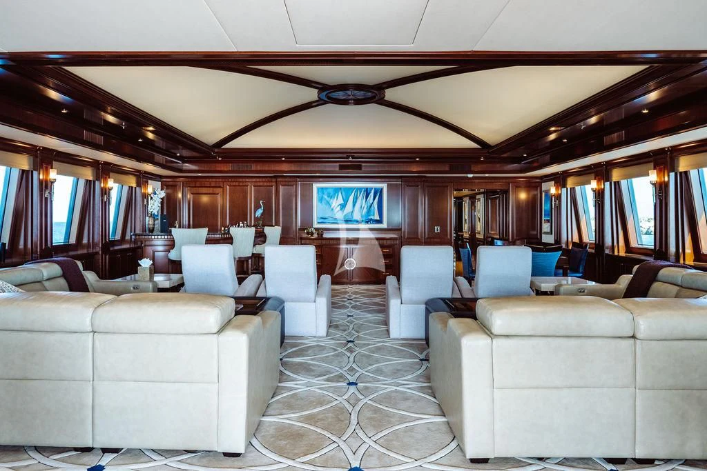 a large room with couches and a television aboard LADY BETH Yacht for Sale