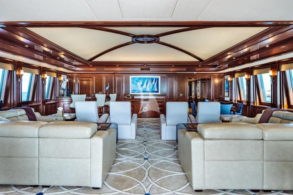 a large room with couches aboard LADY BETH Yacht for Sale