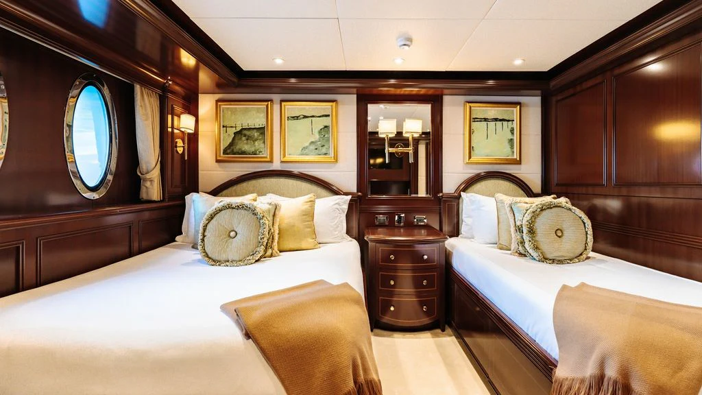 a room with a bed and a mirror aboard LADY BETH Yacht for Sale