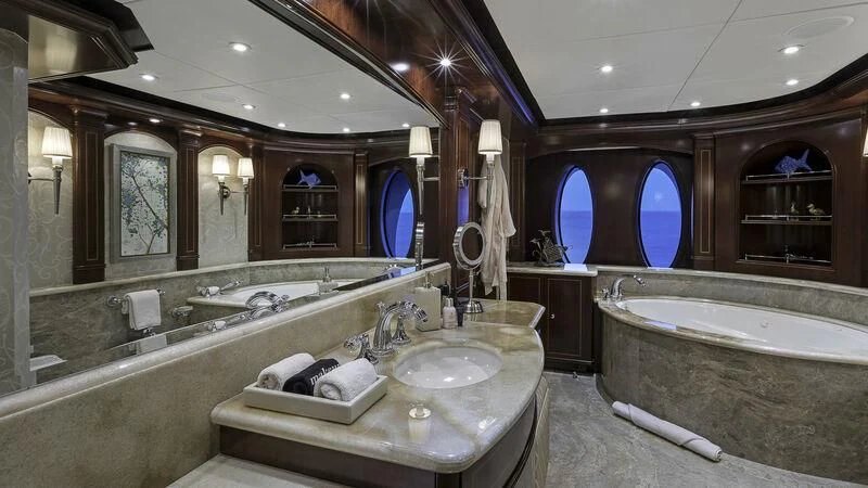 a bathroom with a large bathtub and sinks aboard LADY BETH Yacht for Sale