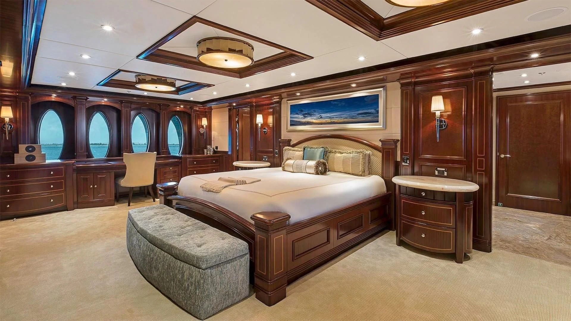 a large bedroom with a bed and a chair aboard LADY BETH Yacht for Sale