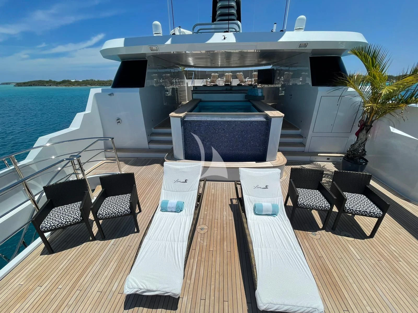 a deck with a table and chairs on it aboard LADY BETH Yacht for Sale