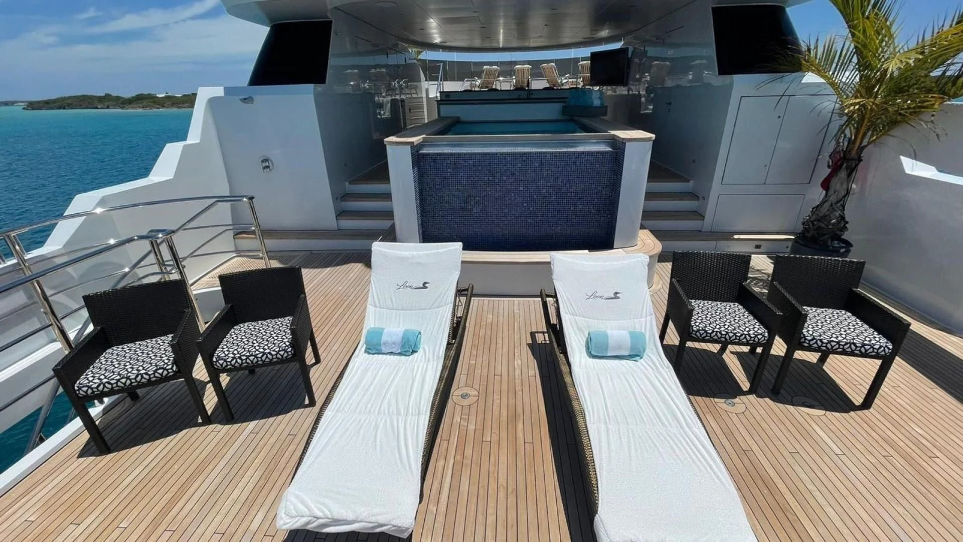 a deck with a table and chairs on it aboard LADY BETH Yacht for Sale