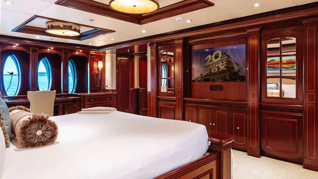 a room with a bed and a desk aboard LADY BETH Yacht for Sale
