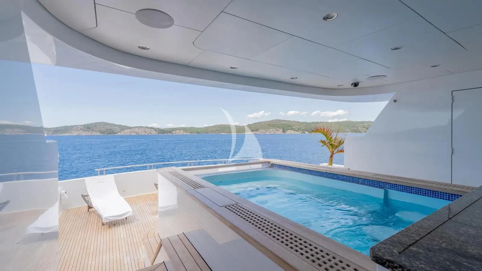 a pool next to a large blue pool aboard LADY BETH Yacht for Sale