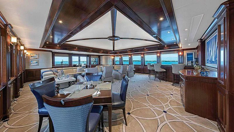 a room with tables and chairs aboard LADY BETH Yacht for Sale