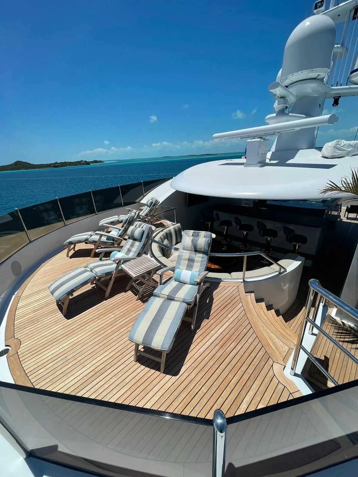 a deck with chairs on it by a body of water aboard LADY BETH Yacht for Sale