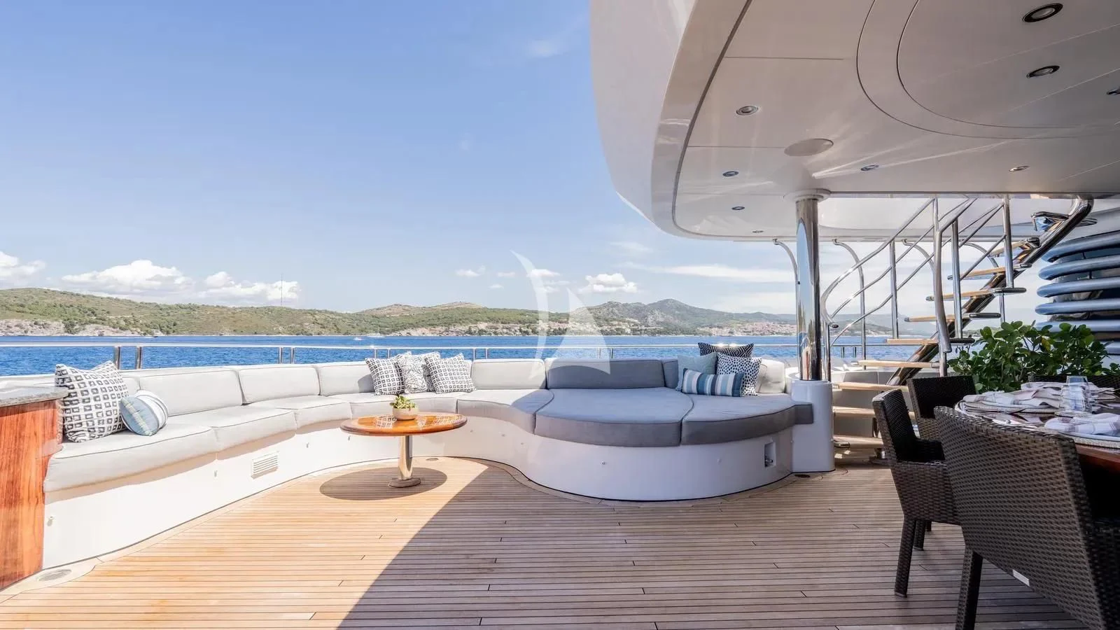 a large lounge area with a large bed and a table and chairs aboard LADY BETH Yacht for Sale