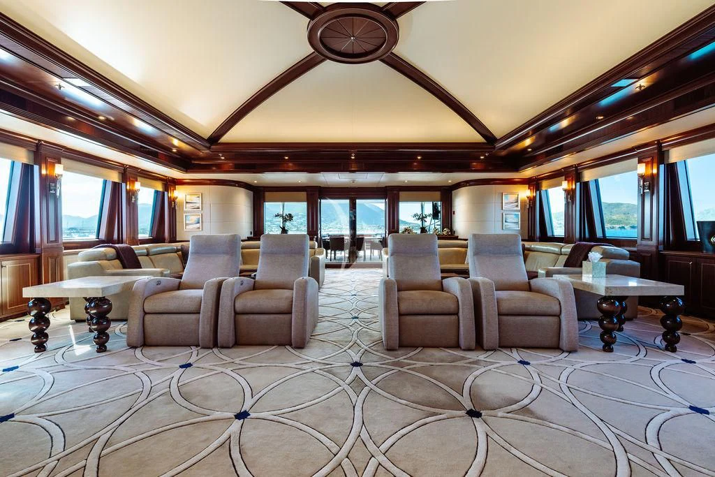 a living room with a chandelier aboard LADY BETH Yacht for Sale