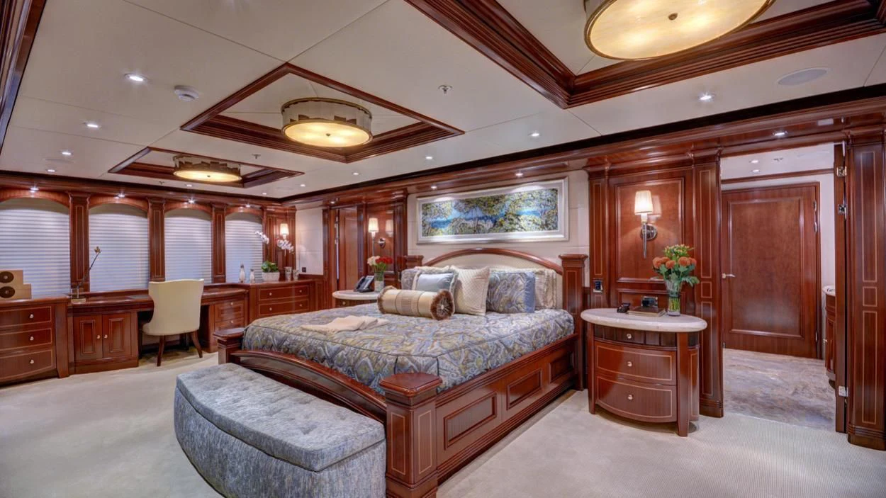 a large bedroom with a bed and a desk aboard LADY BETH Yacht for Sale