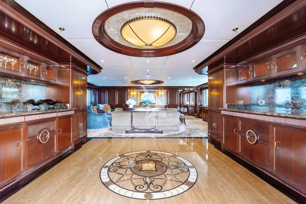 a room with a wood floor and a chandelier aboard LADY BETH Yacht for Sale