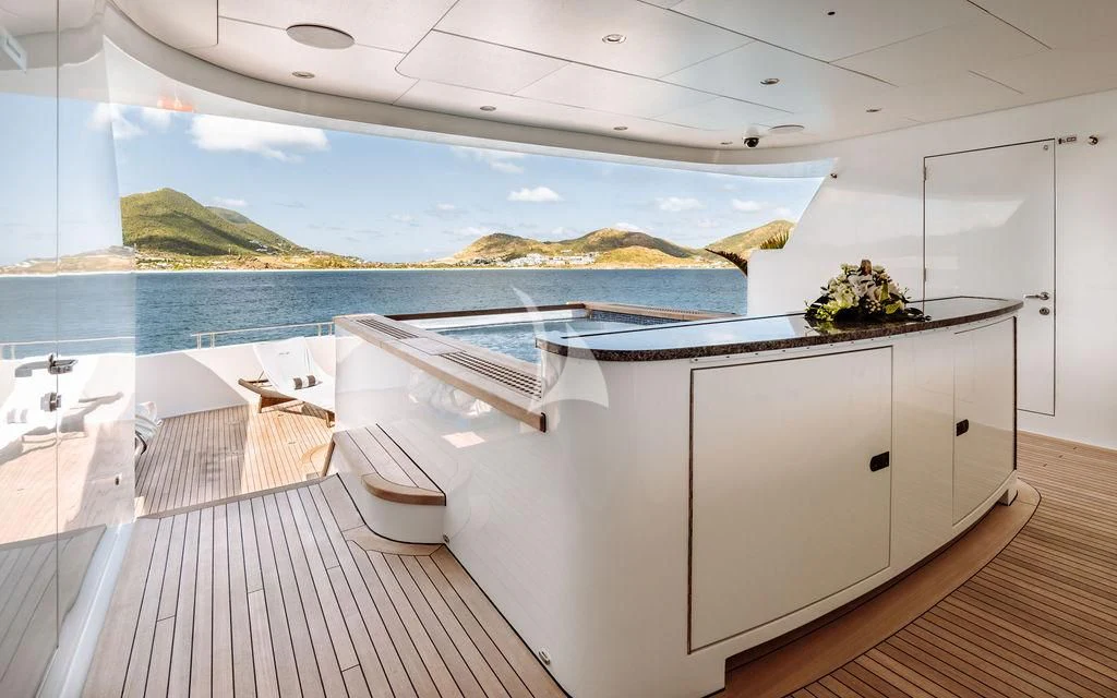 a large white kitchen with a large body of water and a large island aboard LADY BETH Yacht for Sale