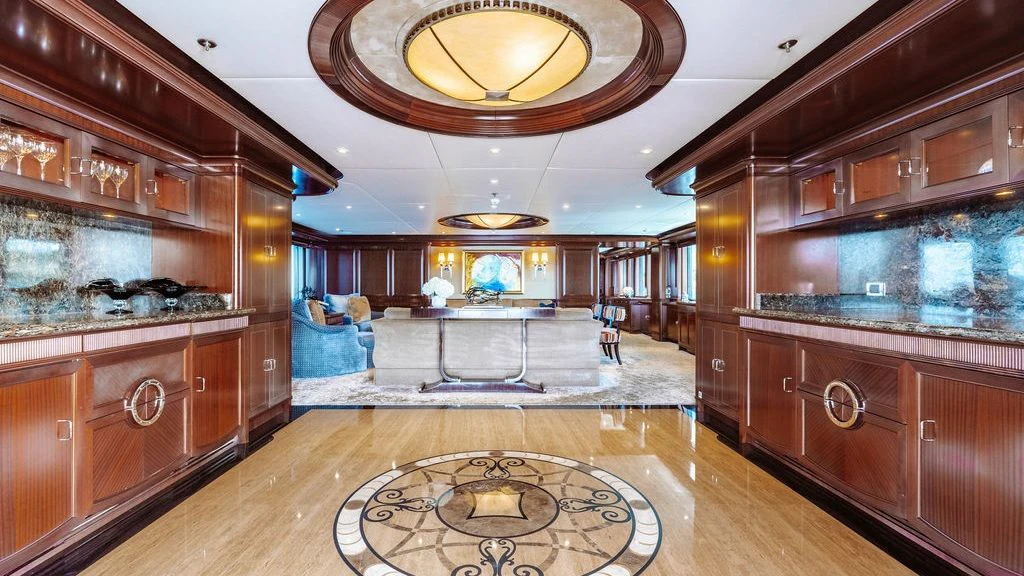 a room with a large wood cabinet and a round rug aboard LADY BETH Yacht for Sale