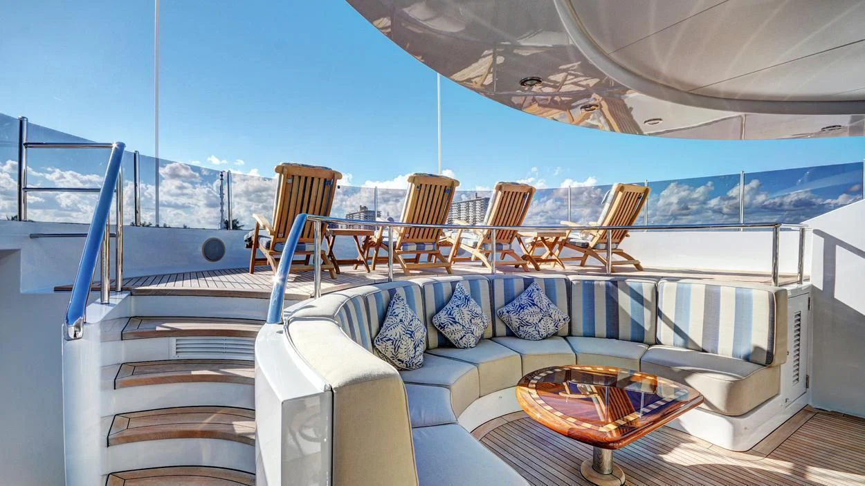 a large white boat with a table and chairs on it aboard LADY BETH Yacht for Sale