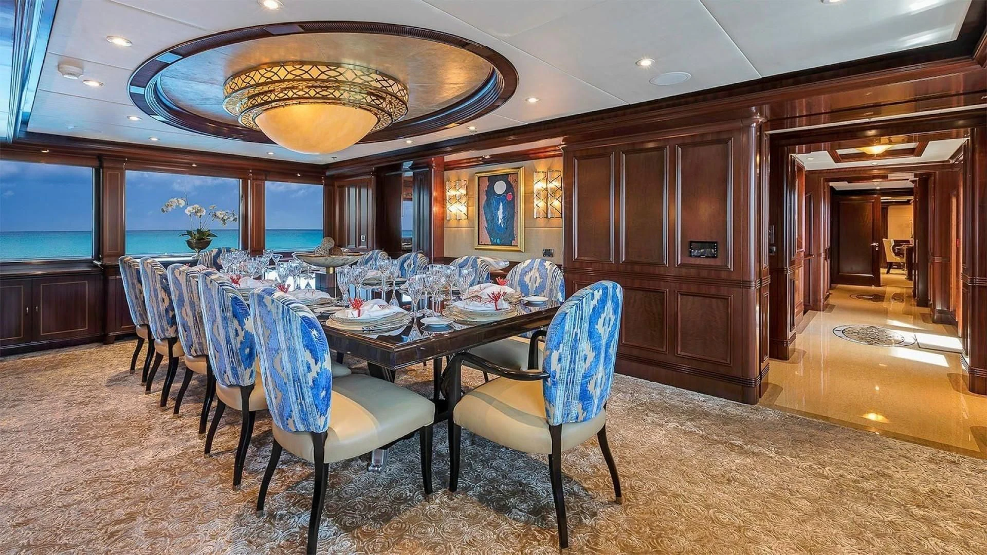 a dining room with a large chandelier aboard LADY BETH Yacht for Sale