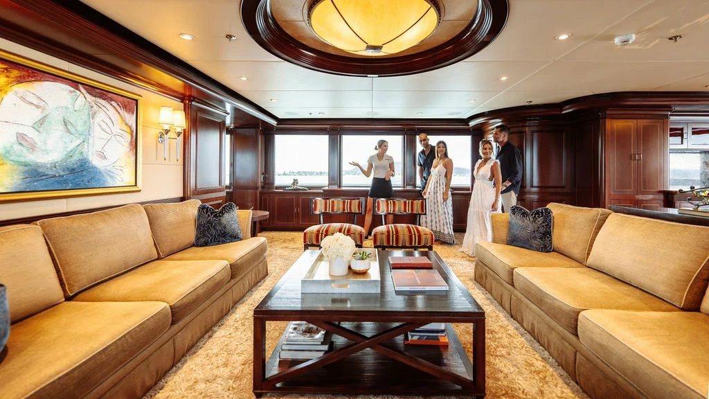 a room with a table and couches aboard LADY BETH Yacht for Sale