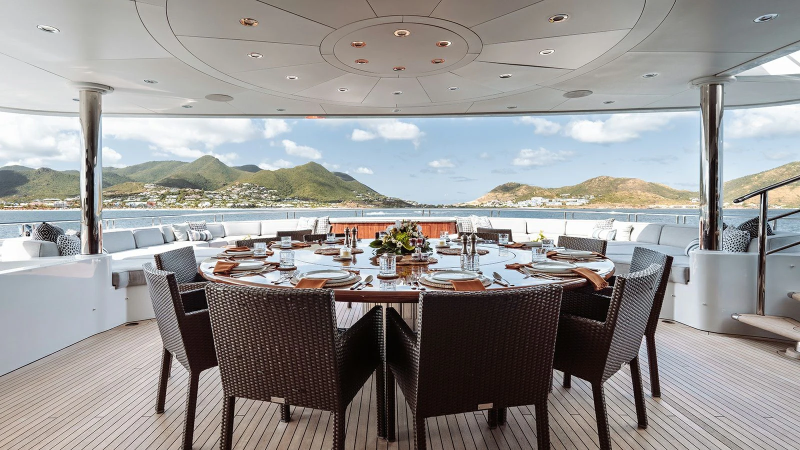 a table set for a meal on a deck overlooking the ocean aboard LADY BETH Yacht for Sale