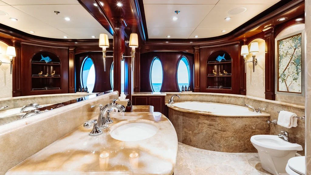 a large bathroom with a large bathtub and sinks aboard LADY BETH Yacht for Sale