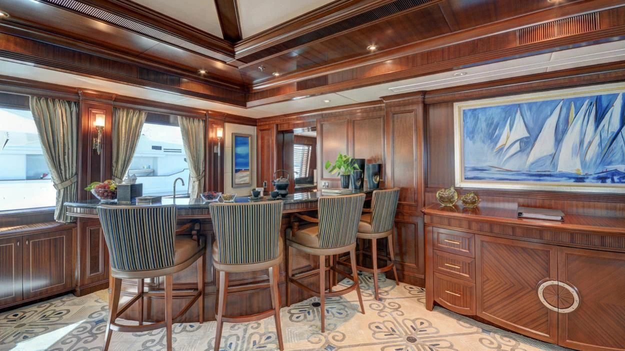 a room with a table chairs and a window aboard LADY BETH Yacht for Sale