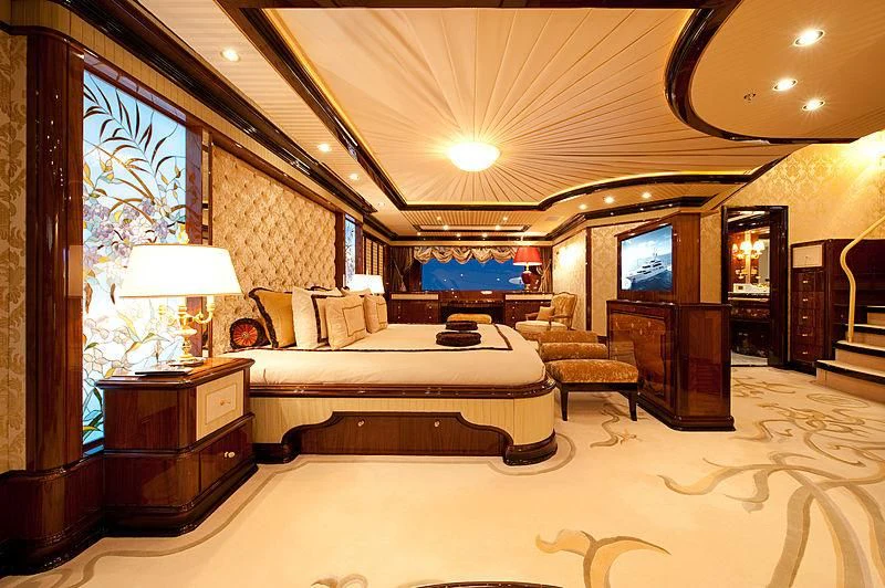 a large bedroom with a large bed aboard DILARA Yacht for Sale