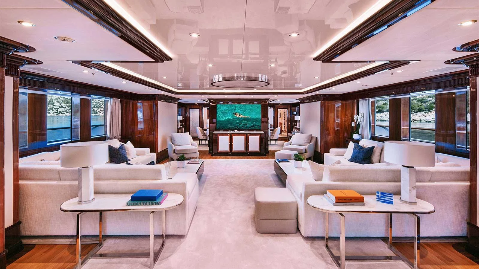 a room with a table and couches aboard DILARA Yacht for Sale