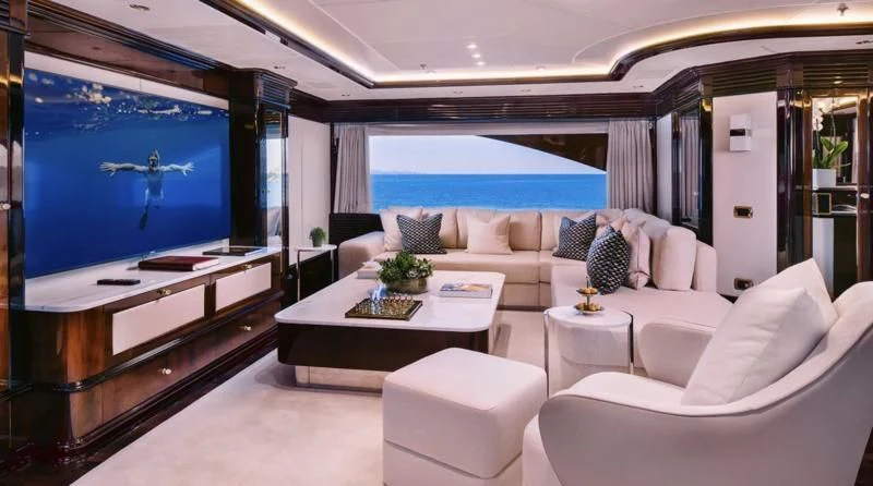 a living room with a large screen aboard DILARA Yacht for Sale
