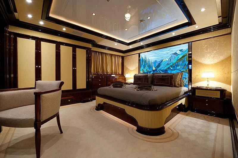 a large bedroom with a large bed aboard DILARA Yacht for Sale