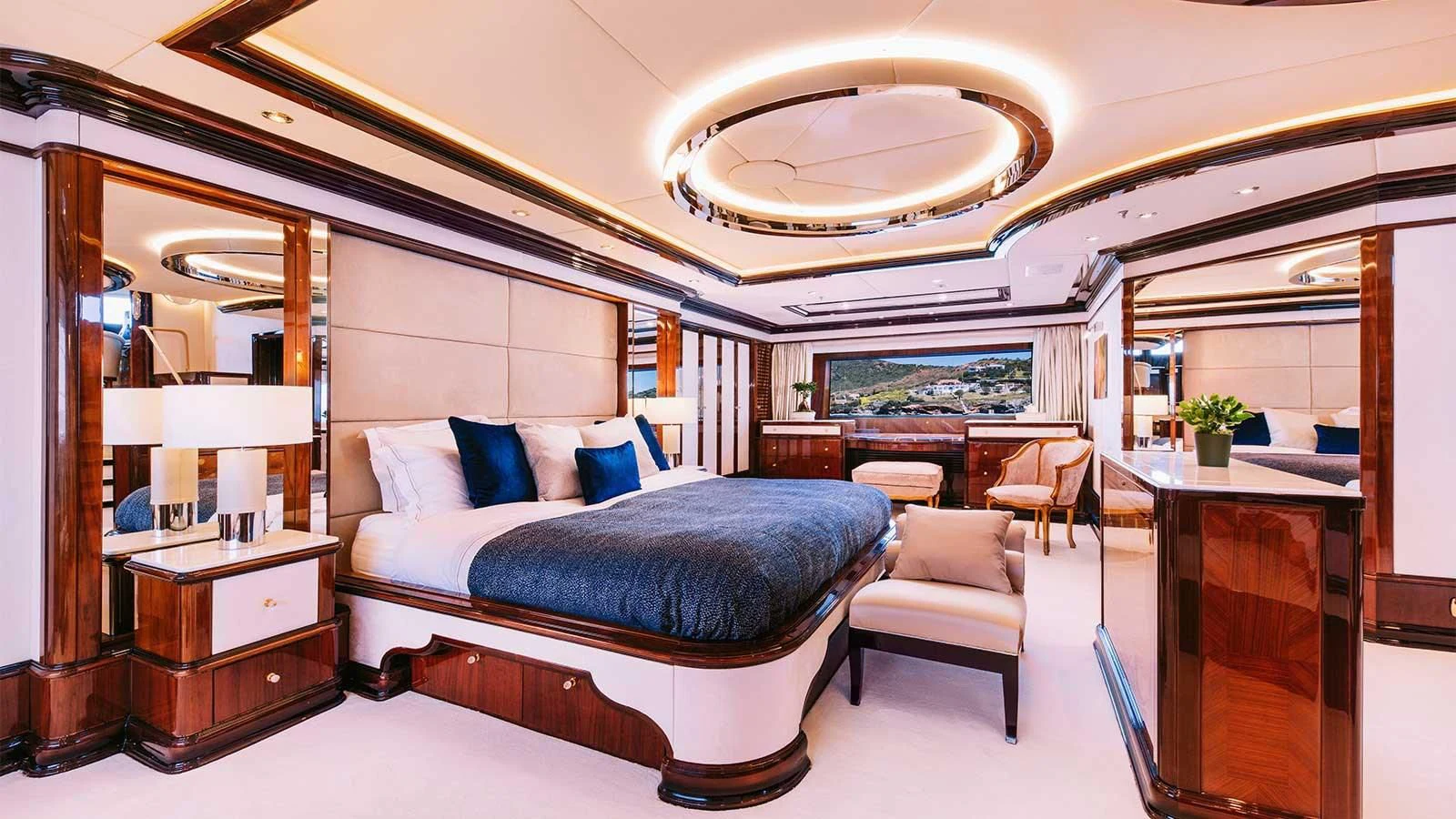 a bedroom with a bed and a desk aboard DILARA Yacht for Sale