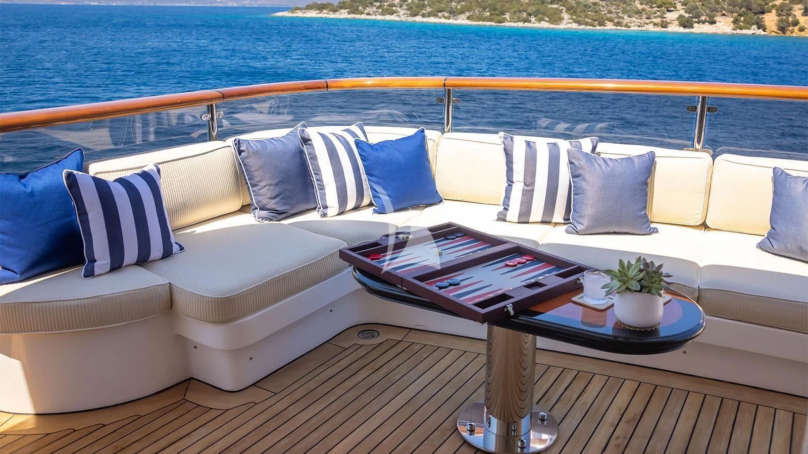 a couch with pillows and a coffee table on it aboard DILARA Yacht for Sale