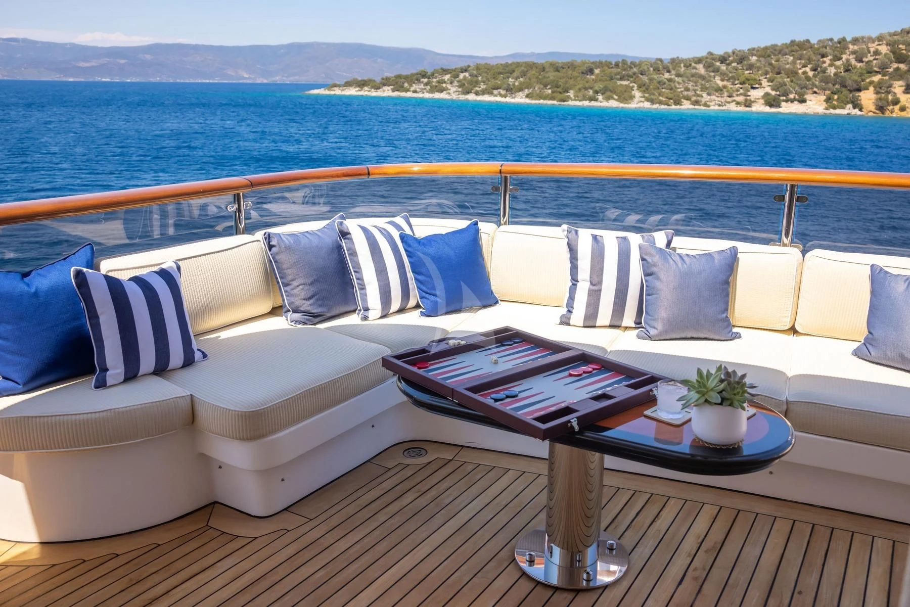 a couch with pillows and a coffee table on it aboard DILARA Yacht for Sale