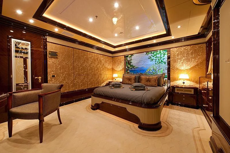 a large bedroom with a bed and a couch aboard DILARA Yacht for Sale