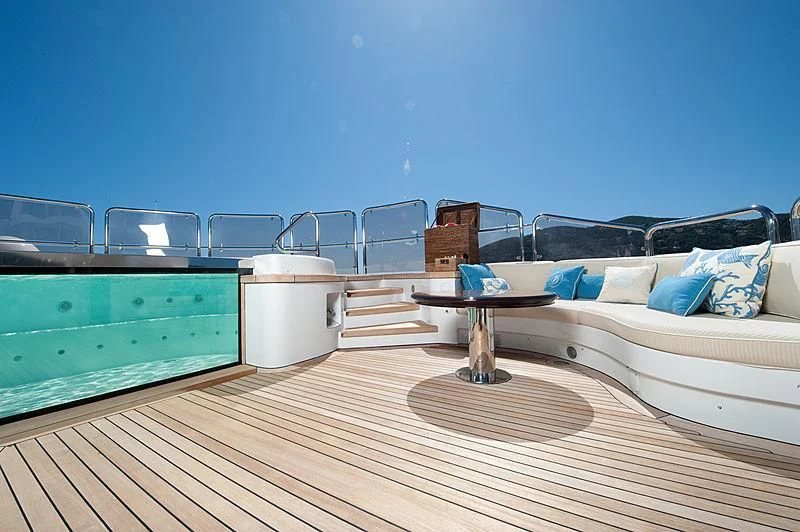 a deck with a couch and a table on it aboard DILARA Yacht for Sale