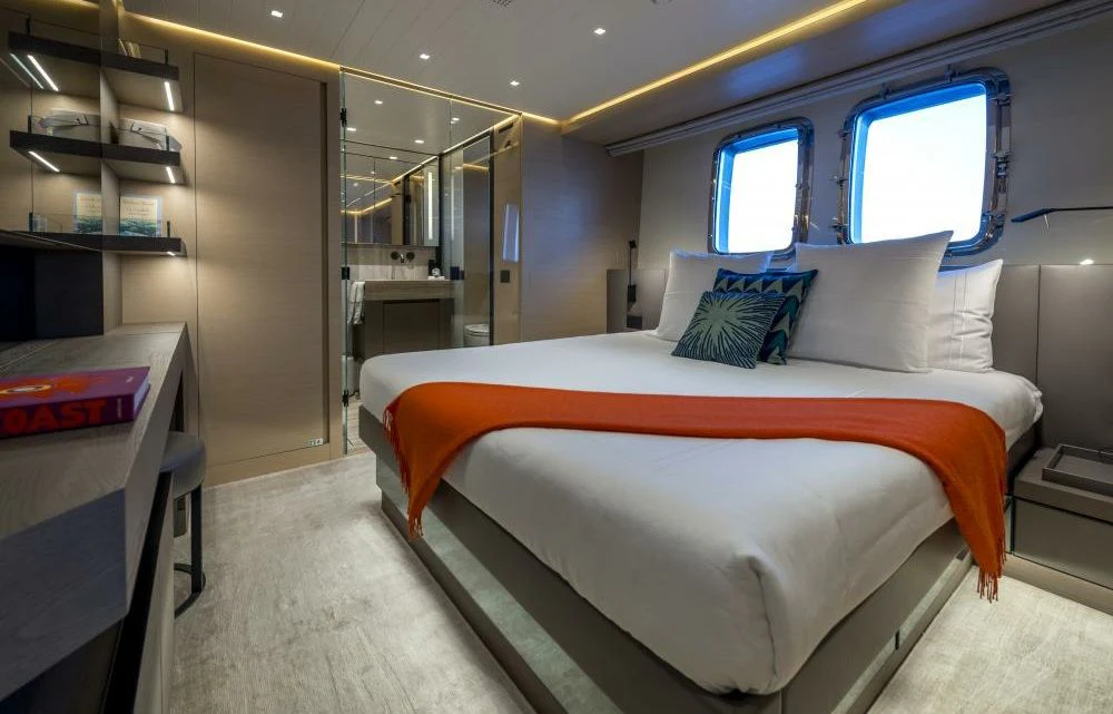 a room with a bed and a window aboard DILARA Yacht for Sale