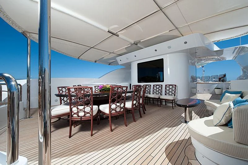 a room with a table chairs and a large window aboard DILARA Yacht for Sale