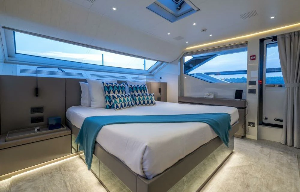 a room with a bed and a window aboard DILARA Yacht for Sale