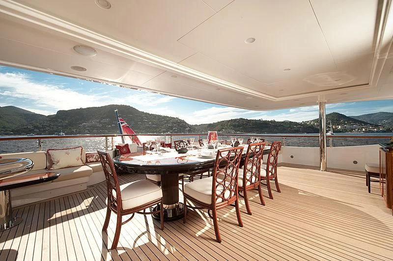 a table and chairs on a deck aboard DILARA Yacht for Sale