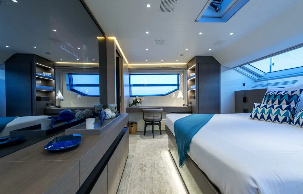 a room with a bed and a desk aboard DILARA Yacht for Sale