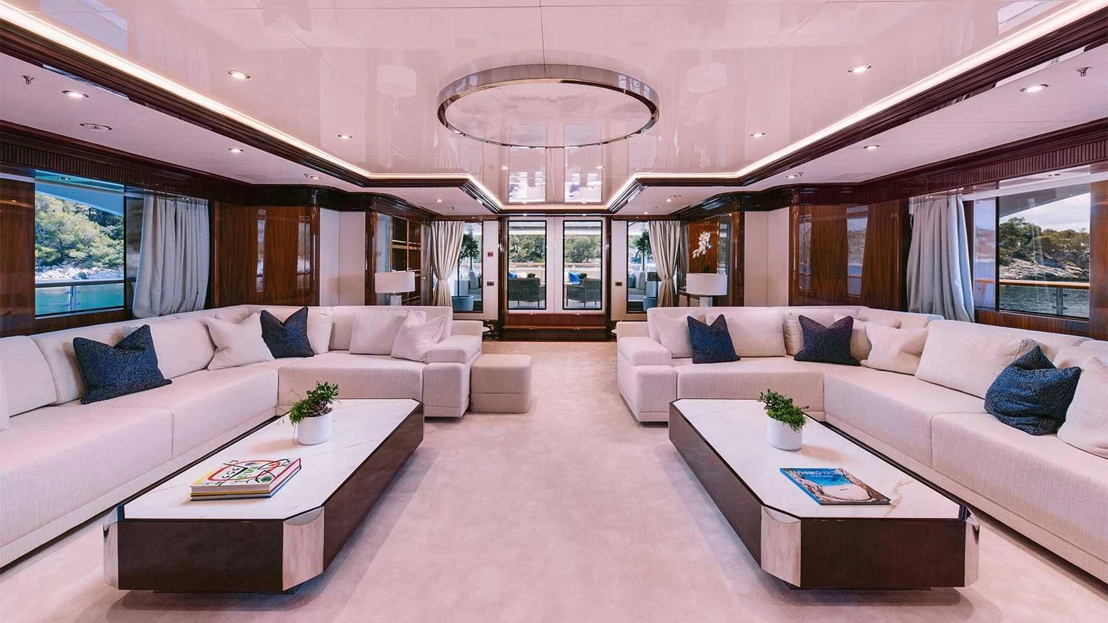 a living room with a large white couch and a large window aboard DILARA Yacht for Sale