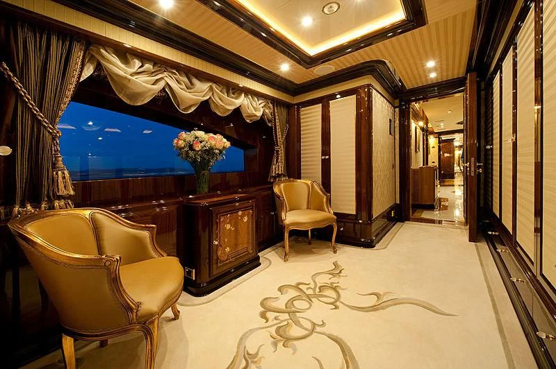 a room with a table chairs and a large window aboard DILARA Yacht for Sale