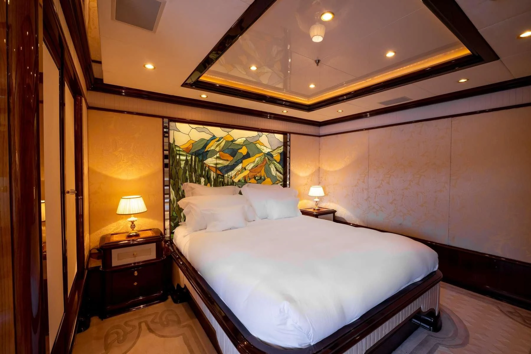 a bedroom with a large bed aboard DILARA Yacht for Sale