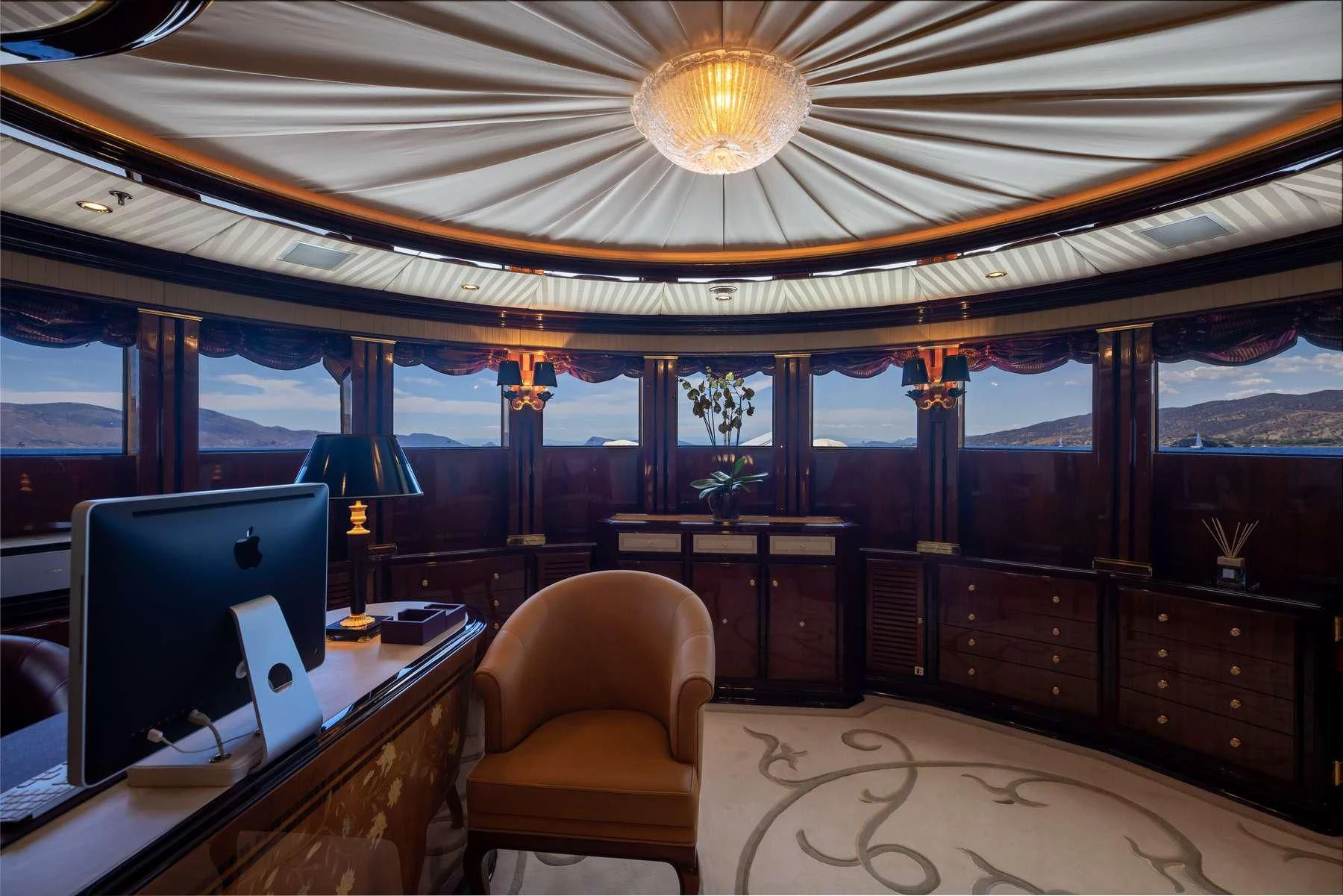 a room with a desk and computer aboard DILARA Yacht for Sale