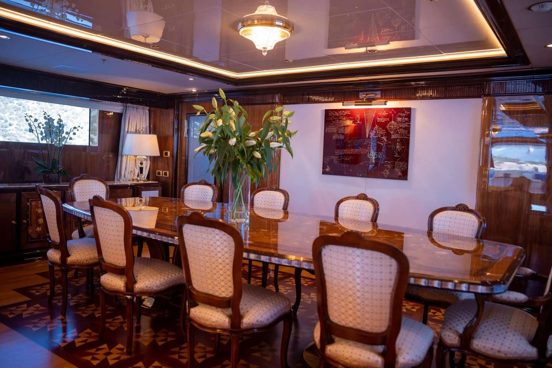 a dining room with a table and chairs aboard DILARA Yacht for Sale