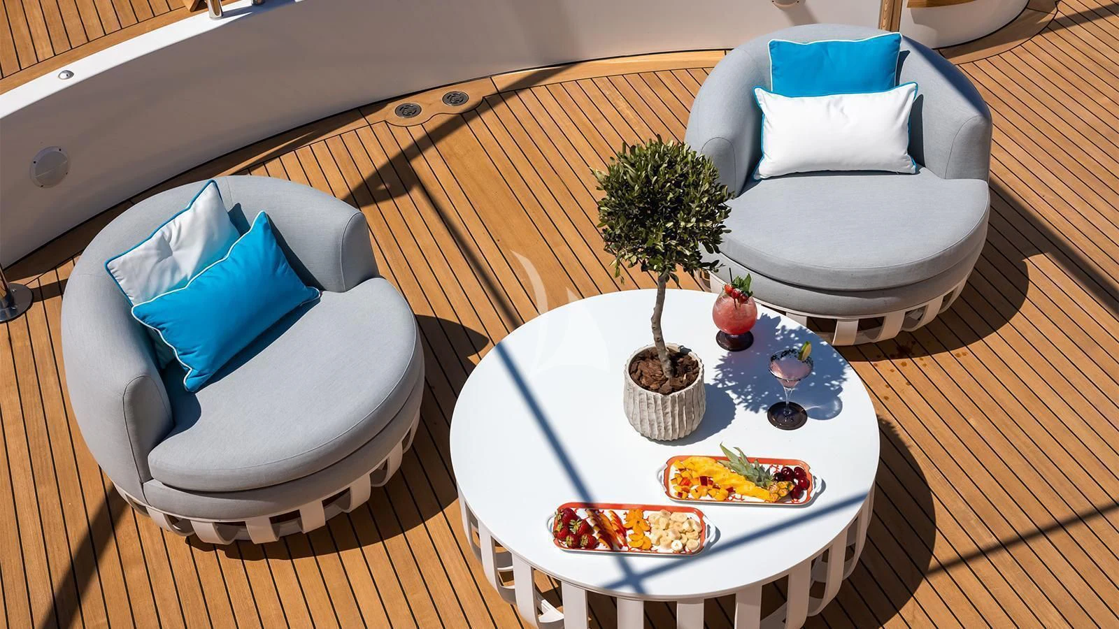a table with a plate of food and a tree aboard DILARA Yacht for Sale