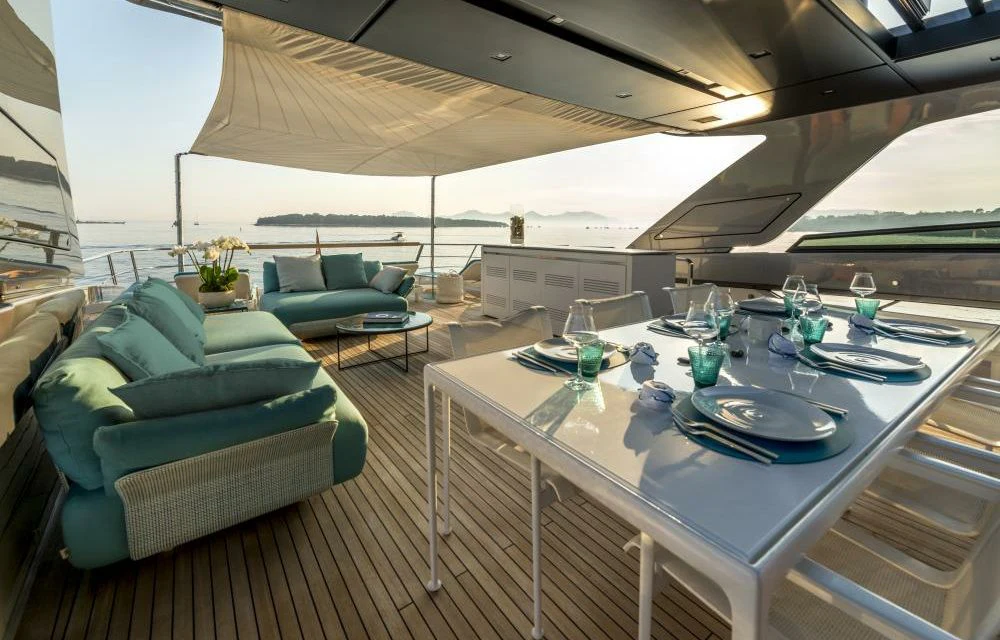 a large white table with chairs and a couch on it aboard DILARA Yacht for Sale