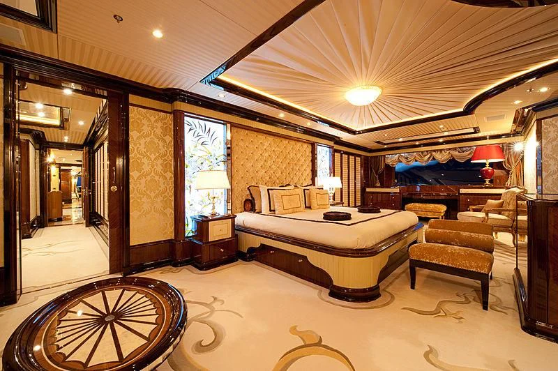 a large bedroom with a large bed aboard DILARA Yacht for Sale