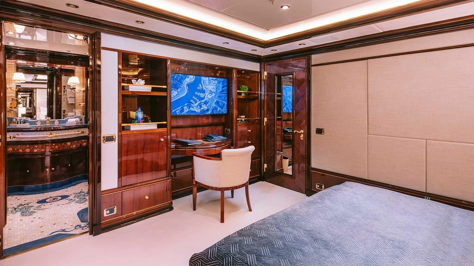a room with a bed and desk aboard DILARA Yacht for Sale