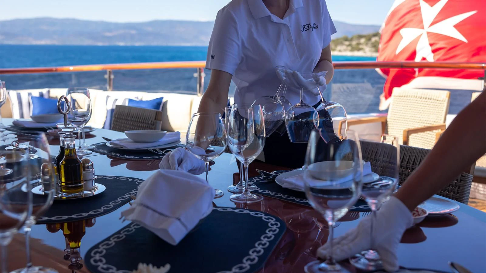 a table with glasses and plates aboard DILARA Yacht for Sale