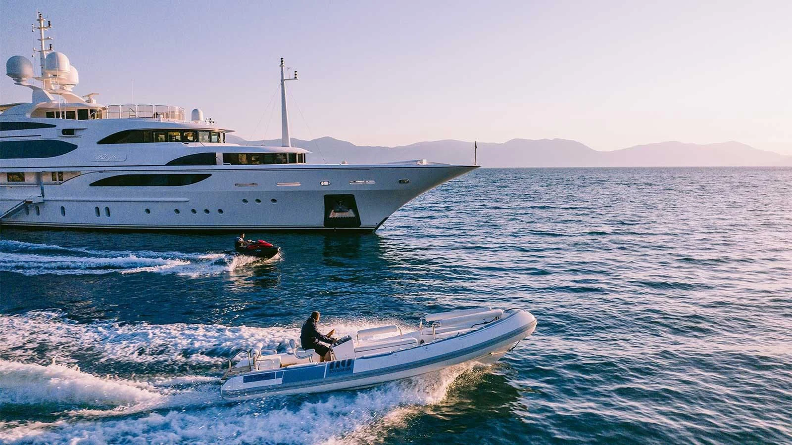 a boat in the water with a boat in the water aboard DILARA Yacht for Sale